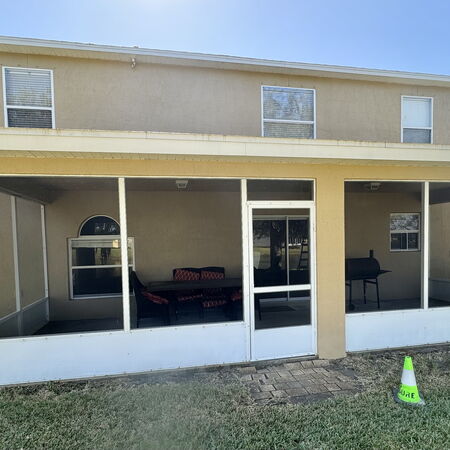 After soft washing dirty yellow stucco house bright and vibrant