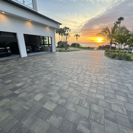 Picture of a completed sealed platinum paver driveway over looki