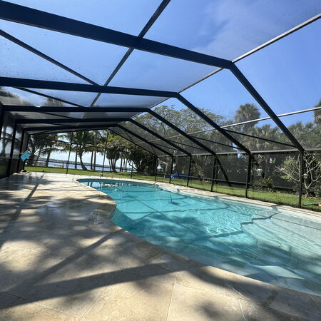 Clean screen enclosure over a pool