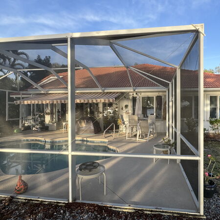 Clean screen enclosure over pool after soft wash