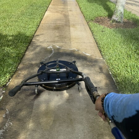 Surface cleaning a long sidewalk before and after