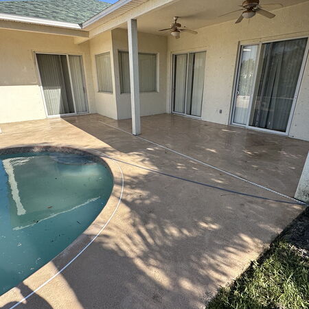 Clean painted texture pool patio in backyard of home