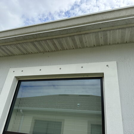 Before photo of dirty gutters soffit and window