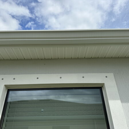 After soft washing photo of window gutters and soffit